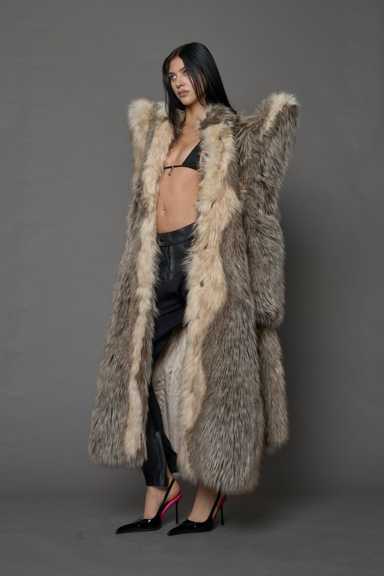 Exaggerated faux fur coat with exaggerated shoulders