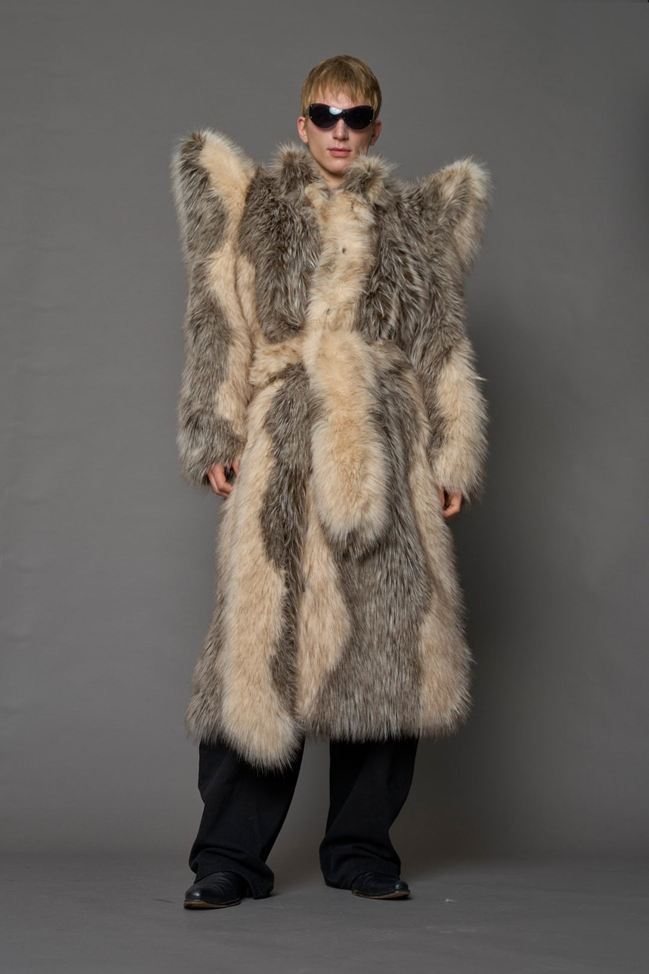 Exaggerated faux fur coat with exaggerated shoulders