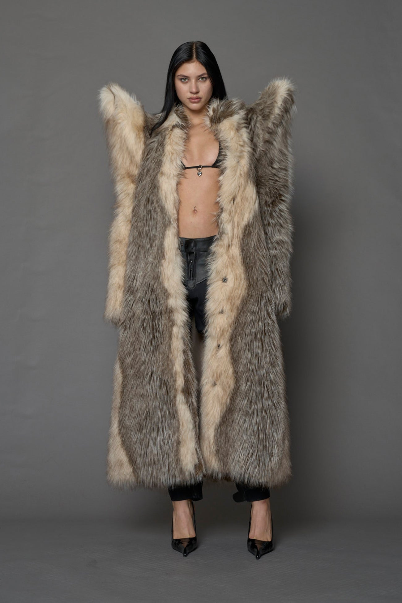 Exaggerated faux fur coat with exaggerated shoulders
