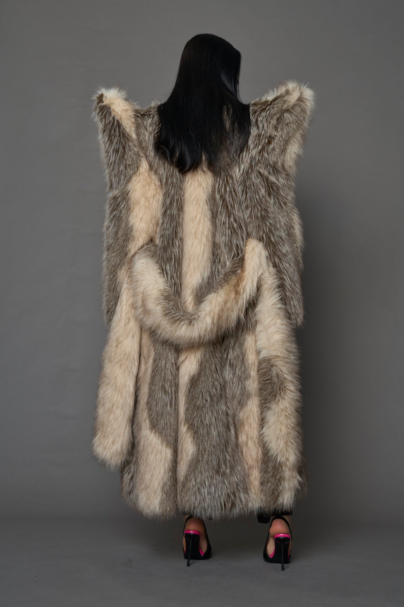Exaggerated faux fur coat with exaggerated shoulders