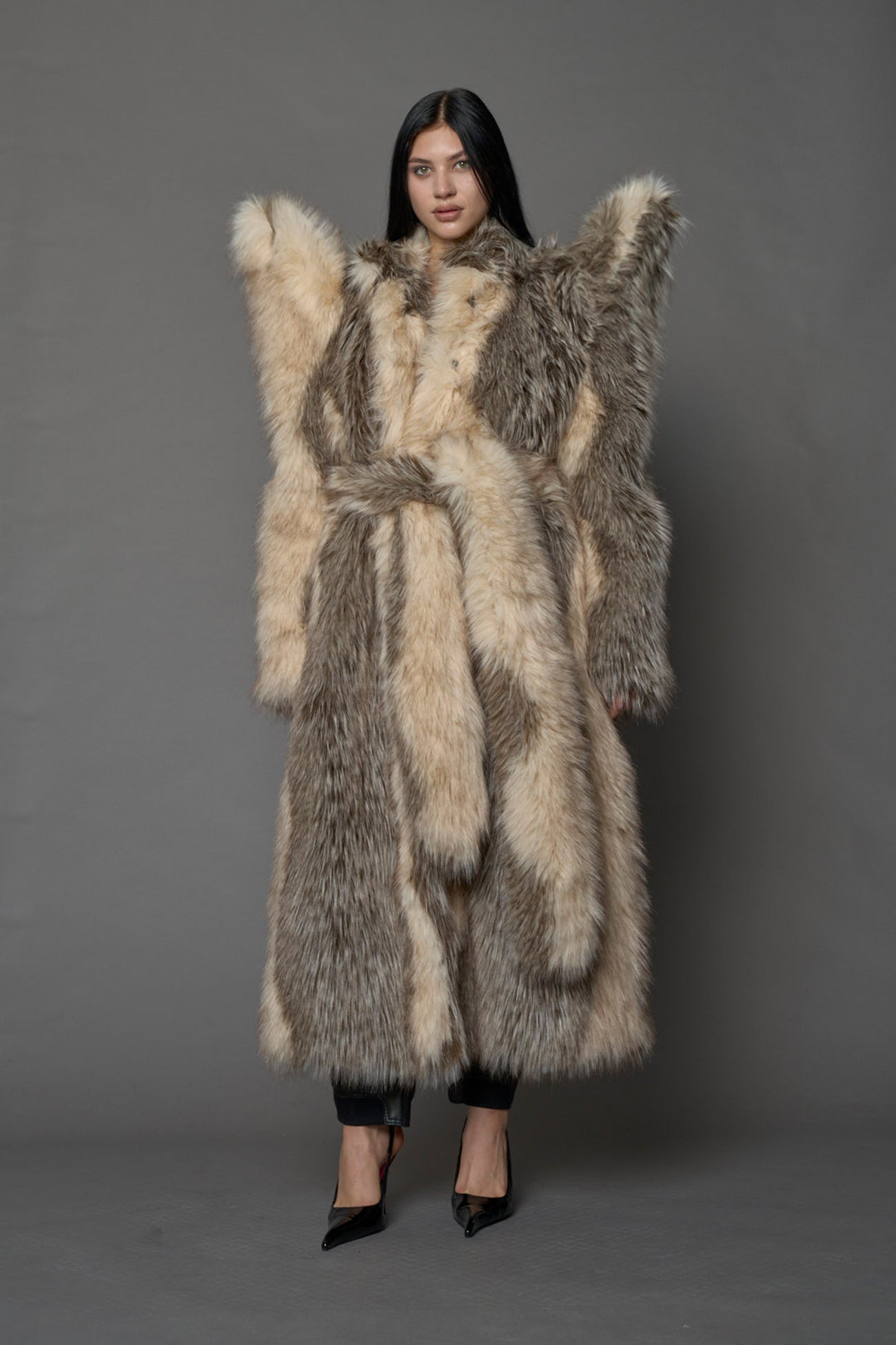 Exaggerated faux fur coat with exaggerated shoulders