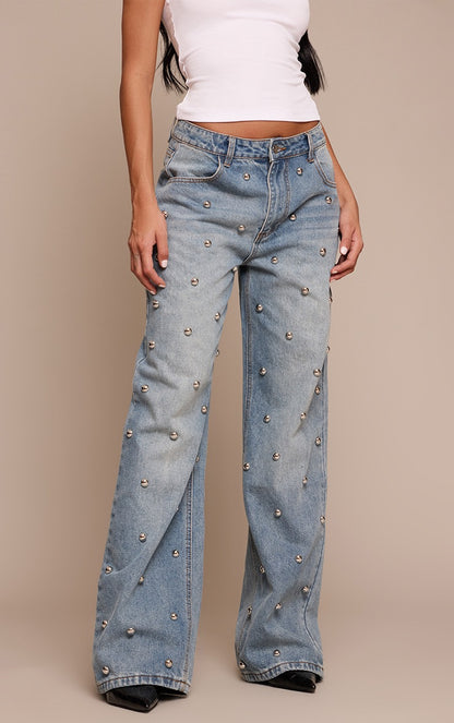 Blue high-waisted jeans with rounded studs