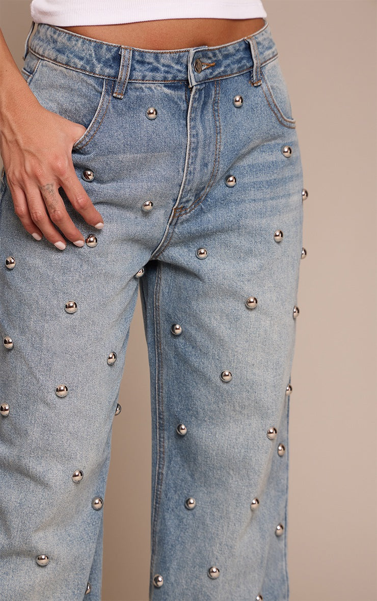 Blue high-waisted jeans with rounded studs